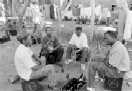 men drinking in front of hostels